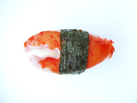 Japanese food. Close up top view of Sushi crab stick roll with seaweed isolated on white background.の写真素材