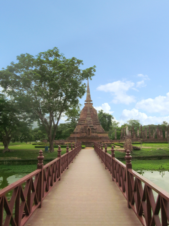 A photo of bridge to the ruin stone of Pagoda at Sukhothai Historical Park on white background, Sukhothai province, one of Thailand's world heritage.のeditorial素材