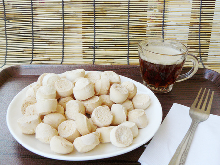 Asia - Asian Thai food, Baking pastry, Thai sweetmeat made of flour, egg and sugar. Its Thai cookies the name is Kanom Ping, on white plate with stainless fork and black coffee on a wooden tray.の写真素材