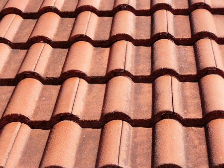 Seamless pattern of red terracotta corrugated tile element of roof in the sunlightの写真素材