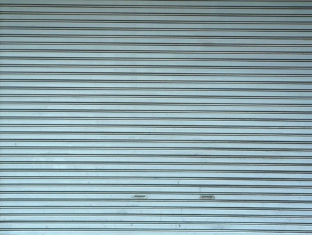 A photo of aluminium steel metal roller shutter door for background.の写真素材