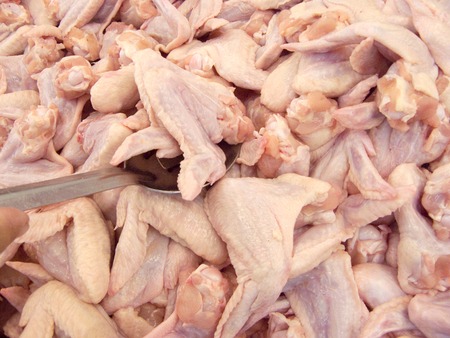 A photo of group of fresh chicken wing or wingstick. Mass product for food industry.の写真素材