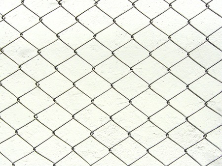 Repeating chain link fence white metal wire mesh or metal net repeats left, right, up and down. The wire mesh fence close up pattern for background and texture isolate on white background.の写真素材