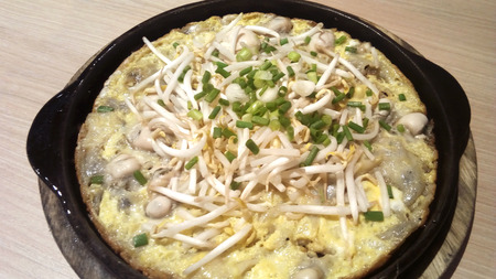 Delicious Asia - Asian eating Thai food, Frying crispy Oyster in a hot iron plate, decorated on the top with bean sprouts and spring onion cut. Served with spicy sauce or ketchup.Thai name is Hoi-Tod.の写真素材