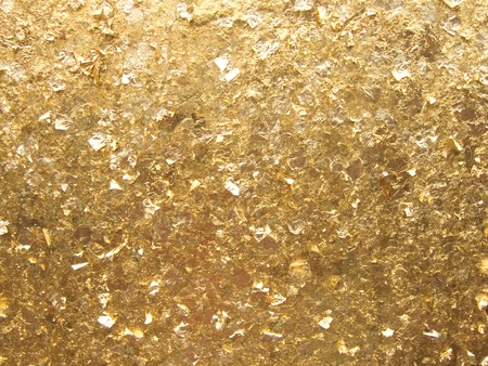 Close up wallpaper of golden background, The gold leaves texture in the sunlight.の写真素材
