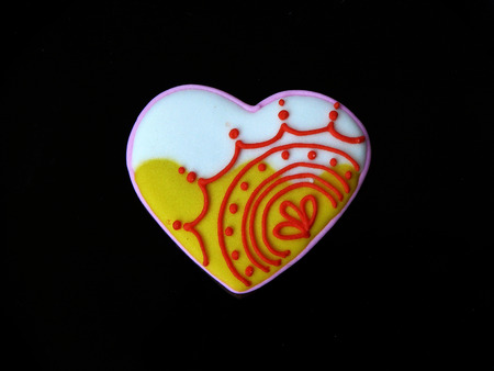 Chocolate lover cookie. Chocolate cookies in sweet heart shape decorated with colorful sugar close up a top view isolated on black background.の写真素材