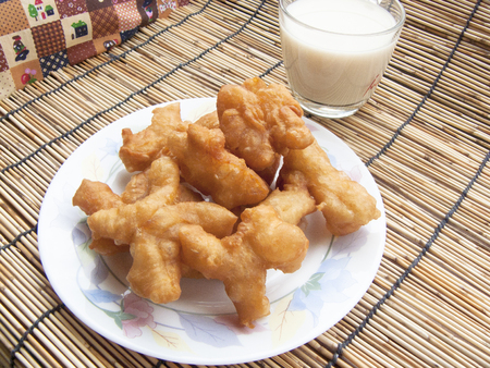 Delicious Asia, Asian eating food. Frying mini Chinese Churros or Chinese Donut with soy milk for breakfast menu. ( Thai name is Patongko )の写真素材