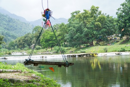 Wooden swing chair near the river.の写真素材