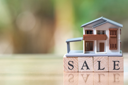 A model house model is placed on wood word sale . as background property real estate concept with copy space for your text or  design.の写真素材