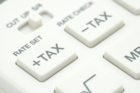 Keypad TAX button For tax calculation. Easy to calculate. on White calculator on white background using as background business concept and Education concept with copy spaces for your text or design.の写真素材