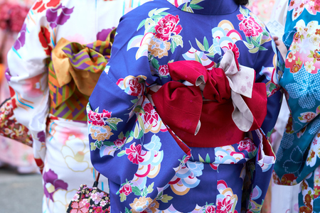 Young girl wearing Japanese kimono standing in front of Sensoji Temple in Tokyo, Japan. Kimono is a Japanese traditional garment. The wordの写真素材