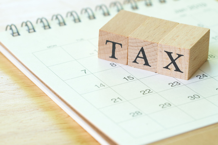 Pay Annual income (TAX) for the year on calculator. using as background business concept and finance concept with copy space  for your text or  design.の写真素材