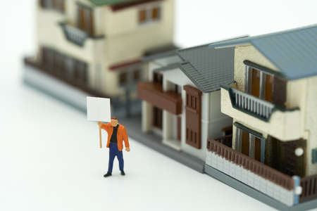 Miniature businessmen standing Investment Analysis Housing Or investment in movable property. using as background business concept and real estate concept with copy space for your text or design.の写真素材