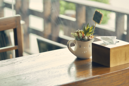 wooden table with a chair in the middle of the lawn. Decorated with vintage flower vases.using as background interior decoration concept with copy space for your text or design.の写真素材