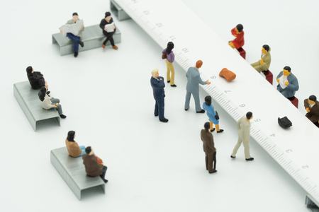 Miniature People use cash deposit. At the bank counter or financial institution. There are many users. as background business concept and Saving concept with  copy spaces for your text or design.の写真素材