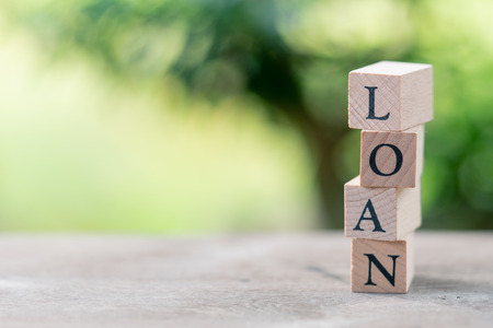 wood word LOAN standing on wood table using as background business concept and finance concept with...