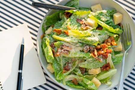 Salads are placed on the table with a notebook and a pen. To record food items or recipes Concept foodie Diet Food Review Weight Loss Dietの写真素材