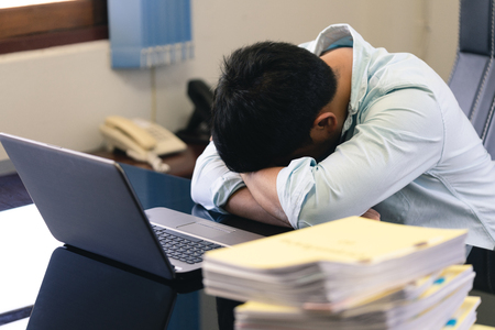 Businessmen are under stress from hard work. The headache is not refreshed, lose health and mental health. as background business concept and strategy concept with copy space.の写真素材