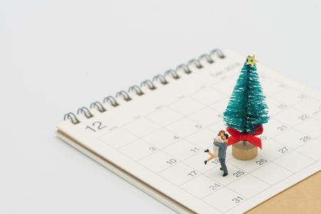 Couple Miniature 2 people standing on Christmas tree Celebrate Christmas on December 25 every year. using as background xmas concept with copy spaces for youの写真素材