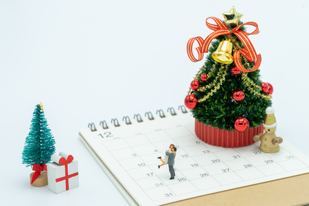Couple Miniature 2 people standing on Christmas tree Celebrate Christmas on December 25 every year. using as background xmas concept with copy spaces for youの写真素材
