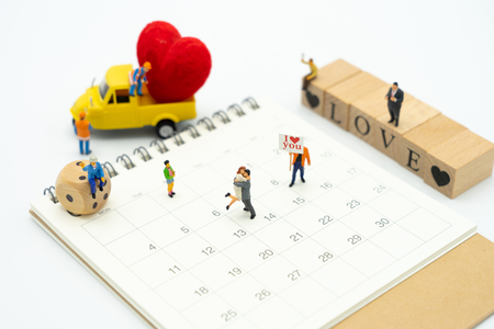Couple Miniature people standing with Red heart is the promise of love. using as background Valentine concept with copy spaces for youの写真素材