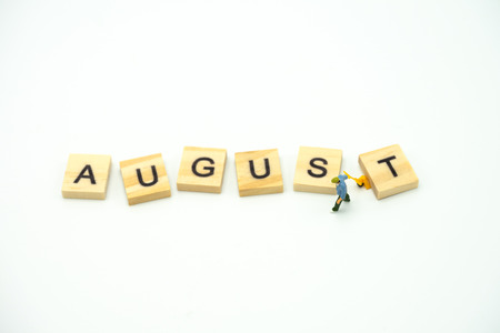 Miniature people Construction worker standing with wood word Month. using as background business concept and calendar concept with copy space  for your textの写真素材