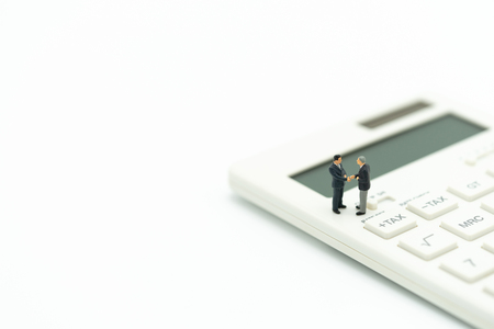 Miniature people Pay queue Annual income (TAX) for the year on calculator. using as background business concept and finance concept with copy space  for your text or  design.の写真素材