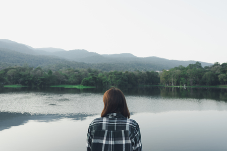 Asian young woman standing facing the sea. Feeling really lonely, heartbroken sea like a nursery of...