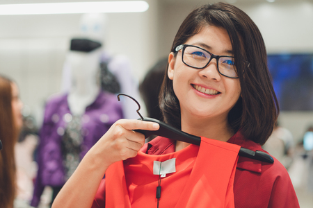 Asian beautiful woman Choose to buy a new set Suitable for season, season according to time, fashion concept, shoppingの写真素材