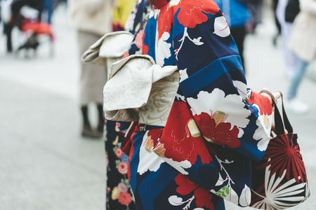 Young girl wearing Japanese kimono standing in front of Sensoji Temple in Tokyo, Japan. Kimono is a Japanese traditional garment. The wordの写真素材