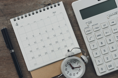 Flat lay of top view office table desk with Calendar, calculators pens and other office supplies as background Workspace and Comfortable work table concept with copy space.の写真素材