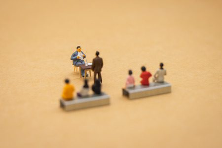 Miniature people businessmen Interview candidates To consider working in the company. The concept used in selecting personnel to participate in the organization. with copy space.の写真素材