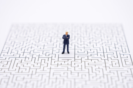 Miniature people businessmen standing in the center of the maze. Business Idea Concepts Troubleshooting Analysis of problems to find solutions.の写真素材