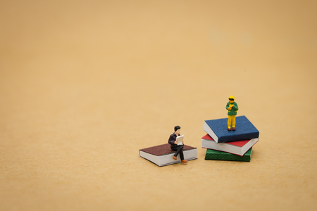 little kids Miniature people standing on books using as background Education concept and Learning concept with copy space and white space.の写真素材