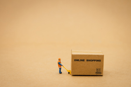 Miniature people Construction worker Online shopping with a shopping cart and shopping bags delivery service using as background shopping concept and delivery service concept with copy spaceの写真素材