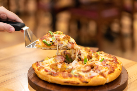 hot pizza dip tray of pizza toppings include ham, pork, paprika and vegetables, pizza, Italian food saurian. View from sideの写真素材