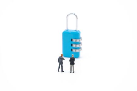 Miniature people businessmen analyze password From the blue key as background business concept and Security concept with copy space.の写真素材
