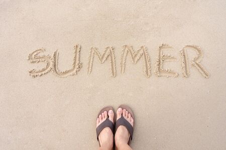 Summer is written on the sand of the sea beach. Is a season of rest and travel People let go of this feeling. Summer and long holiday conceptsの写真素材