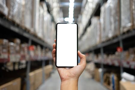 Mockup image of Woman hand holding mobile smartphones isolated white screen for mockup design and others app display background. Graphic design montageの写真素材