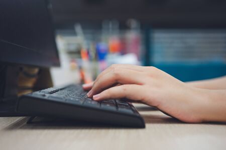 Office worker Using a portable computer on a desk concept works. Staff salaries using as background...