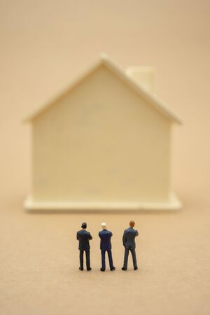 Miniature 3 people businessmen standing with back Negotiating in business. as background business concept and strategy concept with copy space.の写真素材