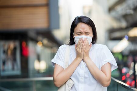 Woman wearing face mask protect filter against air pollution (PM2.5) or wear N95 mask. protect pollution, anti smog and viruses, Air pollution caused health problem. environmental pollution concept.の写真素材