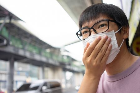 HandsomeMan wearing face mask protect filter against air pollution (PM2.5) or wear N95 mask. protect...