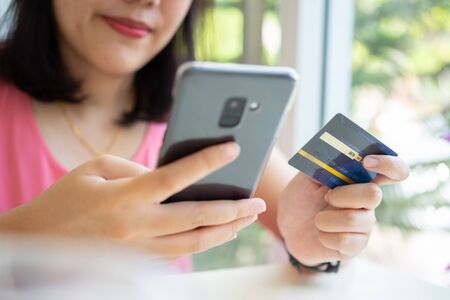 Online shopping with smartphone and shopping bags delivery service using as background shopping...