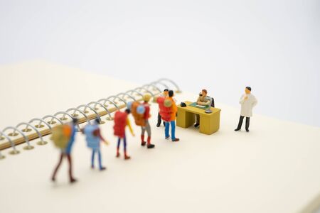 Miniature people traveler and doctor Check the tourists' bodies before entering the country to prevent the spread of communicable diseases. Caused by the virus, the concept of tourism health.の写真素材