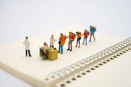 Miniature people traveler and doctor Check the tourists' bodies before entering the country to prevent the spread of communicable diseases. Caused by the 
virus, the concept of tourism health.の写真素材