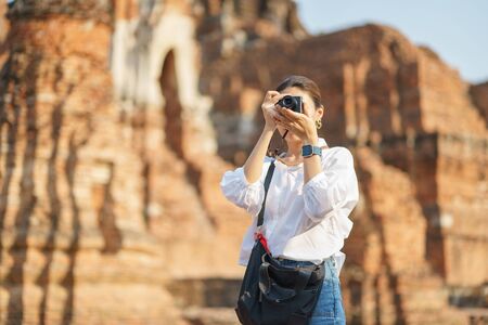 Beautiful Asian tourists Walking, taking photos and traveling on holidays The old town, heritage city Ayutthaya kingdom Phra Nakhon Si Ayutthaya, Thailand