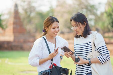 Beautiful Asian tourists Walking, taking photos and traveling on holidays The old town,   city Ayutthaya kingdom Phra Nakhon Si Ayutthaya, Thailandの写真素材