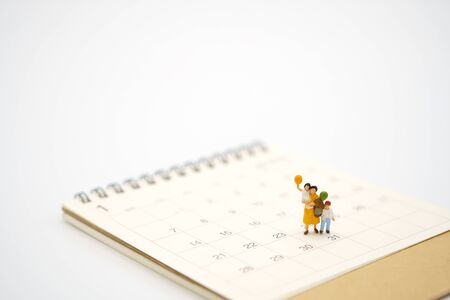 Miniature people businessmen standing on white calendar using as background business concept and finance concept with copy space  for your text or  design.の写真素材