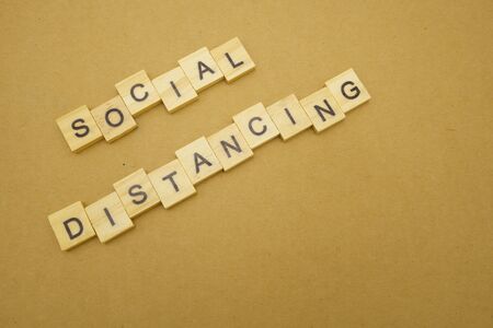 Wood word Social distancing stay apart to reduce Covid 19 virus infection. Maintain social distance...